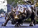 Charging Bull is a 3,200 kg (7,000 pound) bronze sculpture by Arturo Di Modica that sits in Bowling Green park near Wall Street in New York City - free New York City wallpaper, New York State wallpaper from Our New York by Voyageur Press copyright Carl Heilman II
